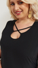 Women's elegant blouse without sleeves with a decorative neckline