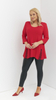 Red women's tunic decorated with a unique braid made of trimmings